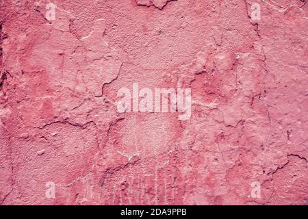 Weathered and cracked concrete pink wall texture as background Stock Photo