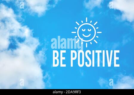 Be positive inspirational or motivational quote against blue sky with clouds background. Positive thinking and attitude concept. Stock Photo