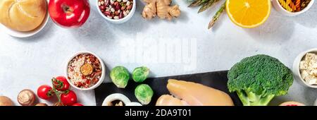 Healthy food panorama with copy space. Top shot of fruits, vegetables, chicken, legumes and rice with a place for text Stock Photo