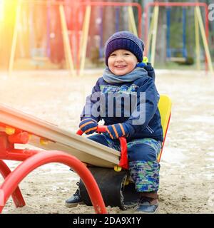 smiling little boy on the seesaw Stock Photo
