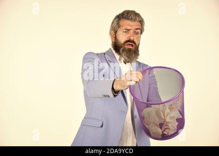 Insure important documents. Recover files after deletion. Businessman hold trash can. Man look for lost document in paper bin. Office worker digging in garbage bin. Recover document. Destroy evidence. Stock Photo