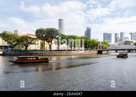 Singapore, 21/01/19. Singapore River with Cavenagh Bridge, only suspension bridge, tourist boast, trees on the river bank, Asian Civilisations Museum Stock Photo