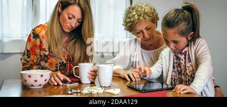 Three female generations using tablet and smartphone Stock Photo