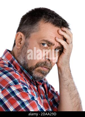 Casual middle aged man with hand near the face with a concerned look Stock Photo