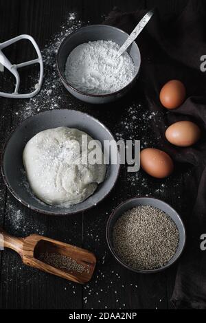 Preparation of a bread with egg flour, sesame seeds, in the middle draws the yeast dough Stock Photo