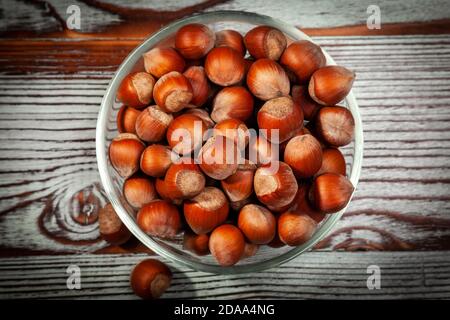 hazelnuts in a glass cup on a wooden background. top view. Stock Photo