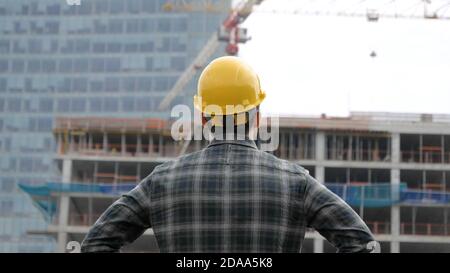 Young engineer looking at construction works. Stock Photo
