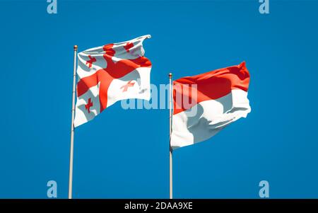 Beautiful national state flags of Georgia and Indonesia together at the sky background. 3D artwork concept. Stock Photo