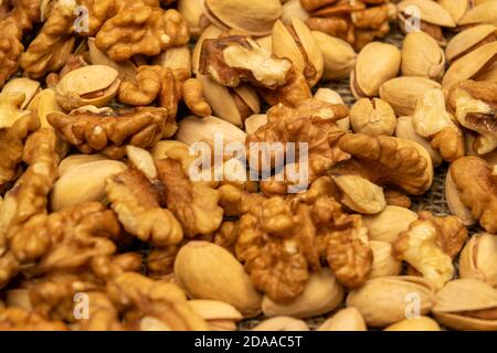 Pistachios and walnuts lie on the sacking. Close up Stock Photo