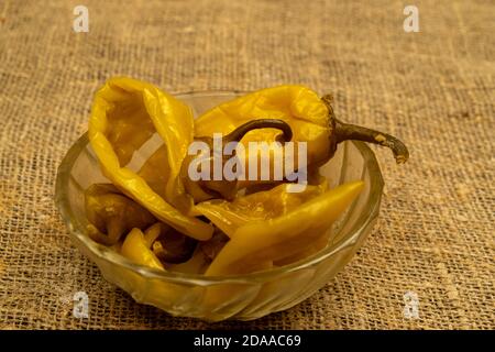 Hot green pepper in a glass dish. Village meal. Close up Stock Photo