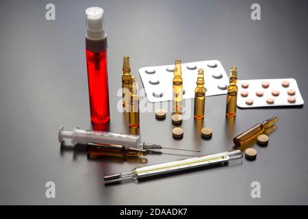 medical ampoules for injection, tablets and syringe. medicines and disease treatment. pharmacology and science Stock Photo