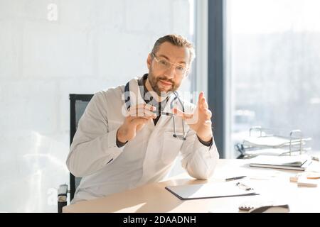 Medical doctor during online consultation. He explains to the patient the features of his diagnosis. Stock Photo