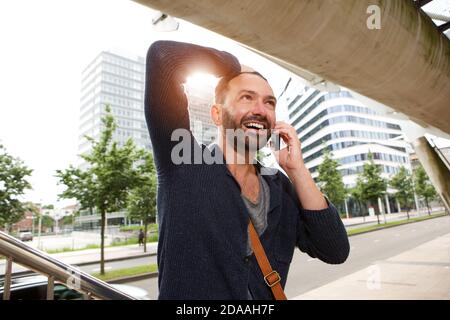 Portrait of happy mature guy talking on cell phone Stock Photo