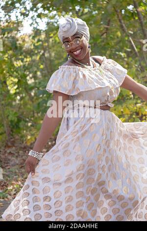 Posed portrait of a very attractive young lady with a distinctive personal style. In a park in Queens, New York City. Stock Photo