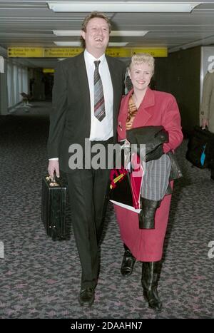 Darts player Eric Bristow with wife Jane Higginbotham at London Heathrow Airport 1991 Stock Photo