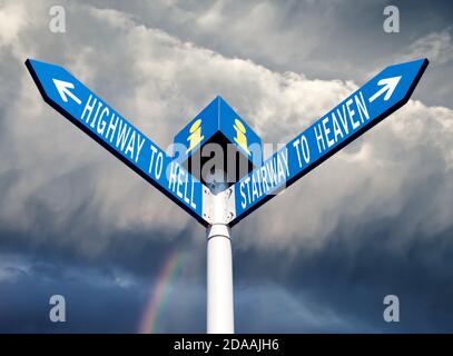 Street post with hell and heaven way signs Stock Photo