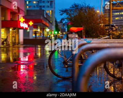 City Bicycle Parking On a Street in a rainy night. Stock Photo