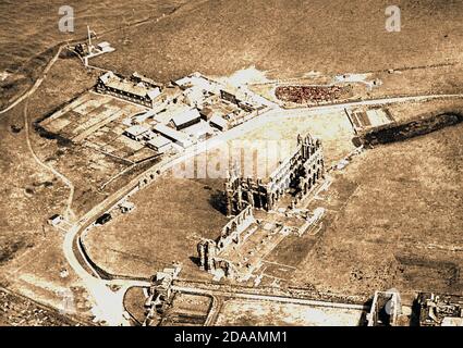 An early aerial photograph of Whitby Abbey & surroundings, It is interesting in that it shows the original two (now only one) abbey fish ponds (top right either side of road), the old coastguard station (top left), coastguard houses and abbey farm. and a  cultivated allotment within in the abbey grounds near the fishpond Stock Photo