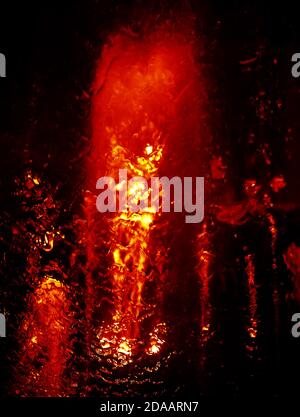 Abstract water grops background in dark red dramatic tone. Water drops and splashing on glass Stock Photo