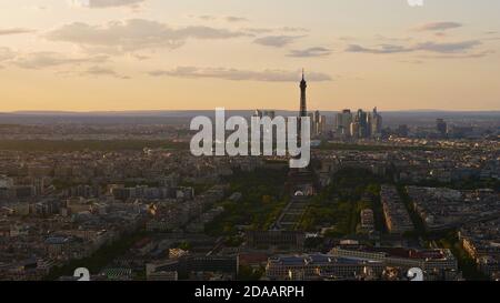 Stunning aerial panoramic view of historic Paris downtown, France with famous Eiffel Tower, park area Champ de Mars and skyscrapers of La Defense.