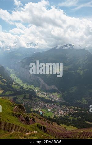 View on the Lauterbrunnen valley with alpine villages Wengen and Lauterbrunnen on overcast day in summer. Seen from top of Mannlichen, Bernese Oberlan Stock Photo