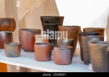 Display of hand made clay cup for tea or coffee at ethnic souvenir fair Stock Photo