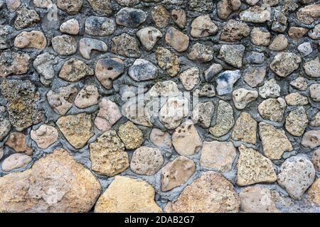 Texture of a stone wall. Old castle stone wall background. Wall made of wild stone. Natural background. Stock Photo
