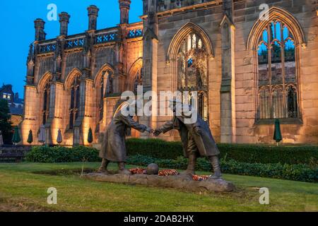 “All together now” statue by Andy Edwards, commemorating the Christmas Day 1914 truce, stands in grounds of St Luke's Church in Liverpool, England, UK Stock Photo