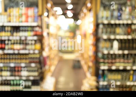 Shelves With Alcohol Drinks In Supermarket, Abstract Blurred Background Stock Photo