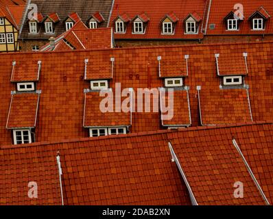 A pattern of red roofs with old windows in a big city Stock Photo