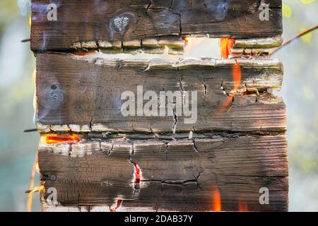 Burning wood billboard close up with copy space. Add your text on it. Stock Photo
