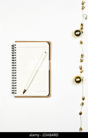 Blank notepad with Christmas decorations. Notepad for writing new resolutions for the new year. Planning the Xmas holidays. Copy space Stock Photo
