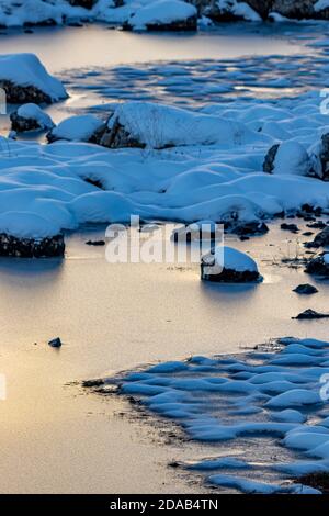 Frozen lake in high mountains, early light Stock Photo