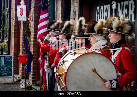 Saint Charles, MO--Dec 19, 2018; Salvation Army actors recreate historic Fife and Drum corp band in colonial dress near collection kettle. Stock Photo