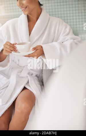 Cropped woman in the terry towel showing the knee Stock Photo