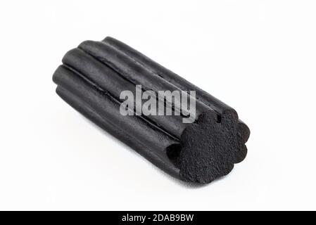 Macro shot of black licorice candy, isolated on a white background. Stock Photo