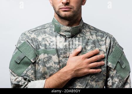 cropped view of patriotic military man in uniform pledging allegiance isolated on white Stock Photo