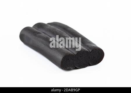 Macro shot of black licorice candy, isolated on a white background. Stock Photo