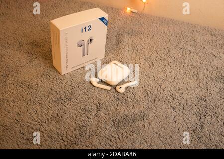 Wireless white headphones isolated on gray plush Stock Photo