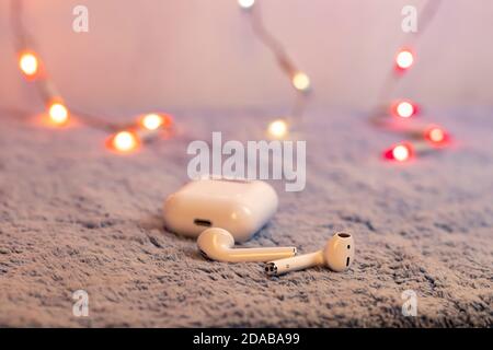 Wireless white headphones isolated on gray plush Stock Photo