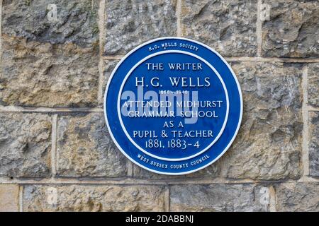 Blue plaque for the writer H G Wells on a wall at Midhurst Grammar School, North Street, Midhurst, a town in West Sussex, south-east England Stock Photo