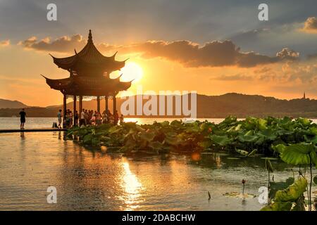 Beautiful sunset under light rain on West Lake in Hangzhou, China with Jixian Pavillion and the Lotus Pool. Stock Photo