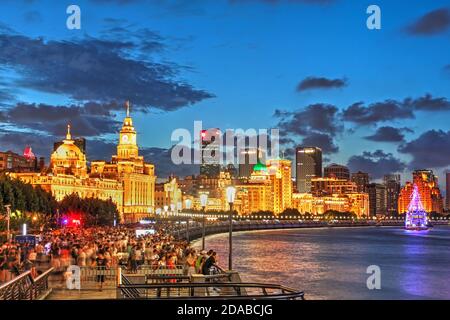 Night scene along the Bund in Shanghai, China, featuring most of the iconing collonial buildings facing the Huangpu River. Stock Photo