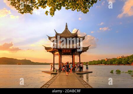 Beautiful sunset under light rain on West Lake in Hangzhou, China with Jixian Pavillion and the Lotus Pool. Stock Photo