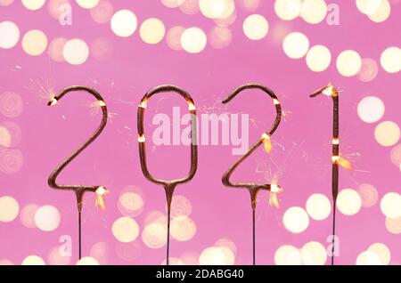 Burning festive sparklers in the shape of 2021 digits Stock Photo