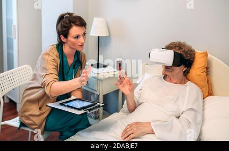 Older patient using virtual reality glasses Stock Photo