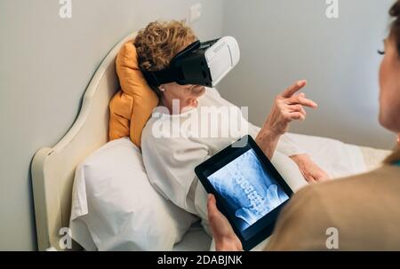 Older patient using virtual reality glasses Stock Photo