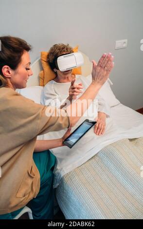 Older patient using virtual reality glasses Stock Photo
