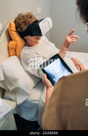 Older patient using virtual reality glasses Stock Photo
