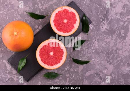 Grapefruits sliced ​​on a gray background. Flat lay. Stock Photo